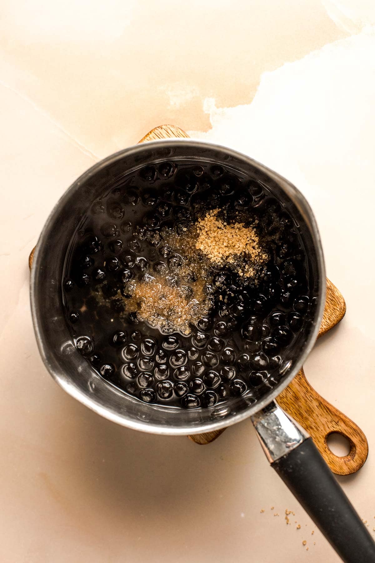 A cooking pan filled with tapioca pearls and sugar.