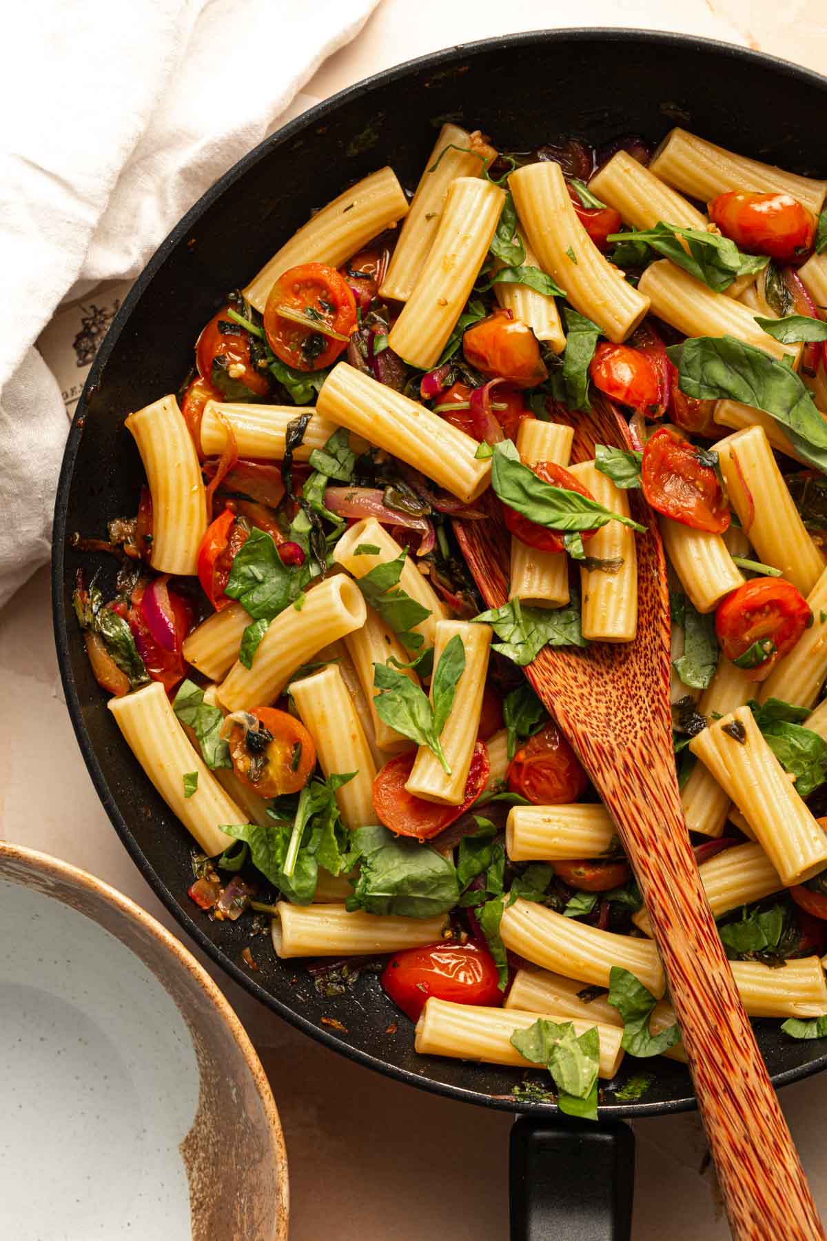 A large skillet filled with pasta.
