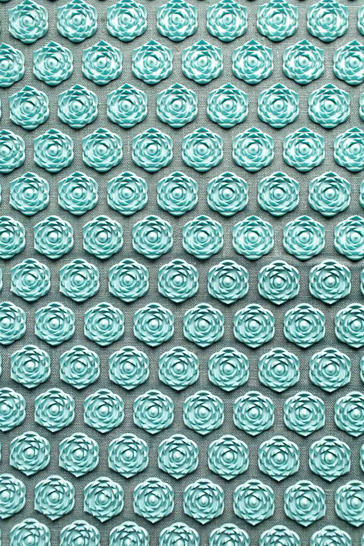A Pranamat ECO acupressure mat in a blue color.