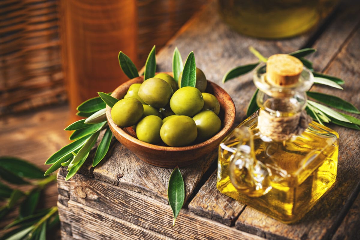 Image of olives and olive oil in rustic style, still life.