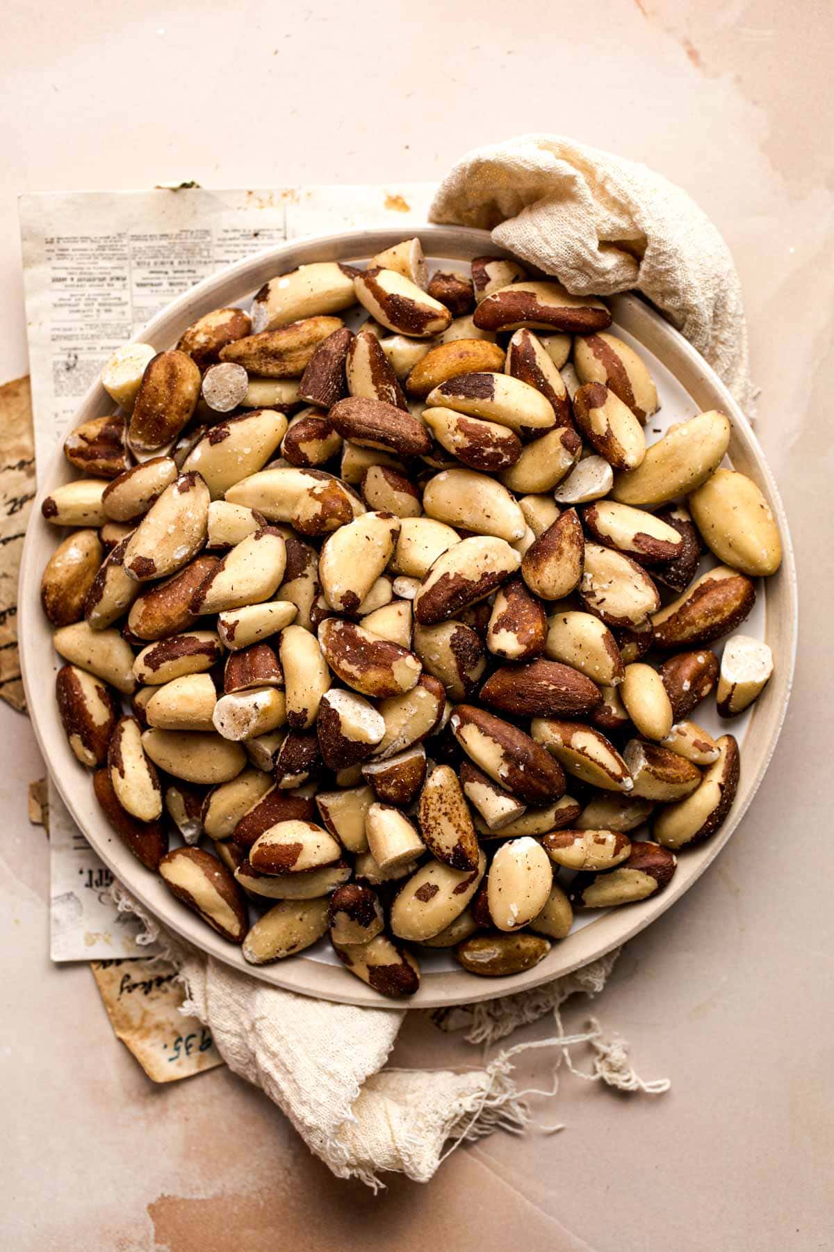 Whole brazil nuts on a plate.