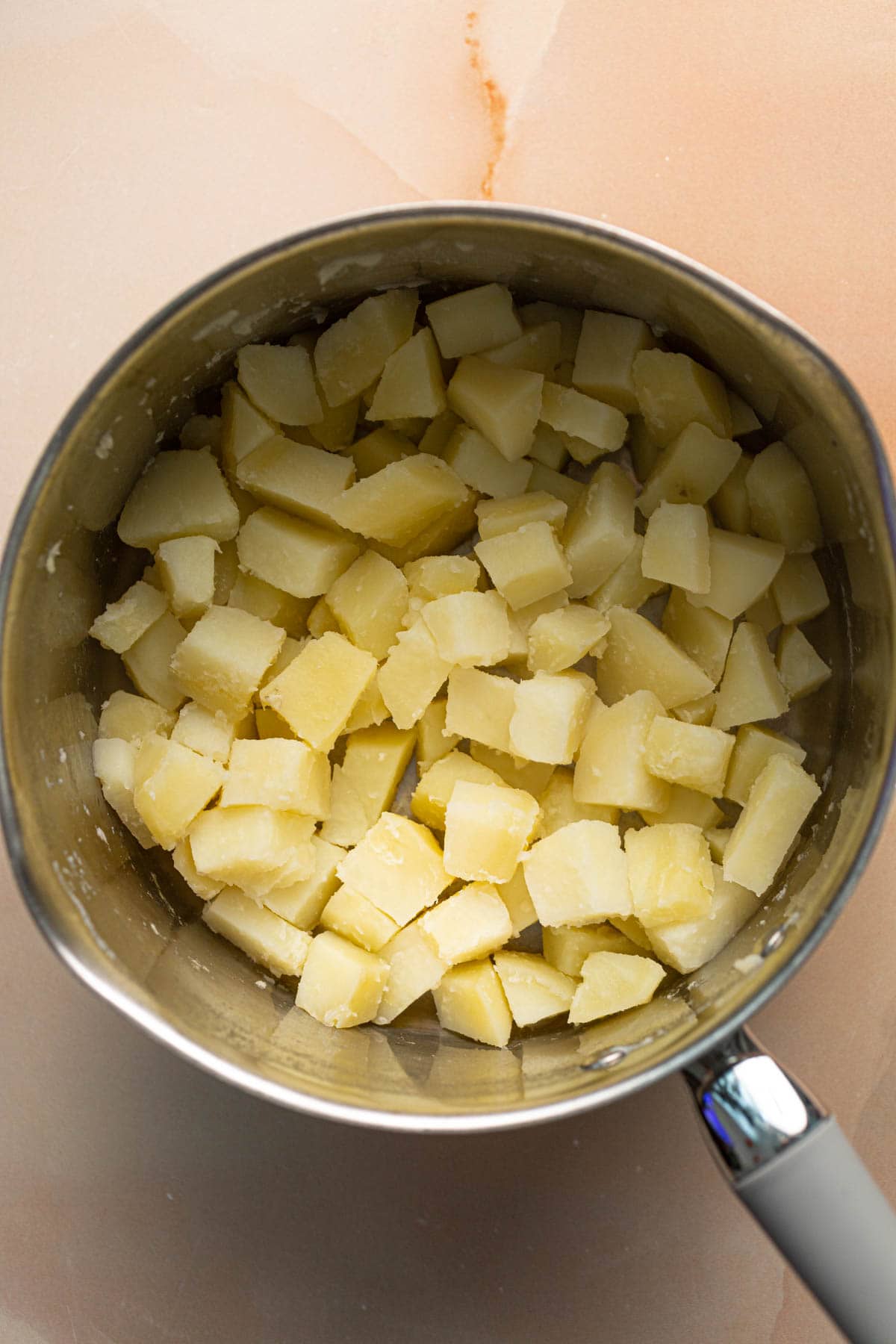 Boiled potatoes in a large pan.