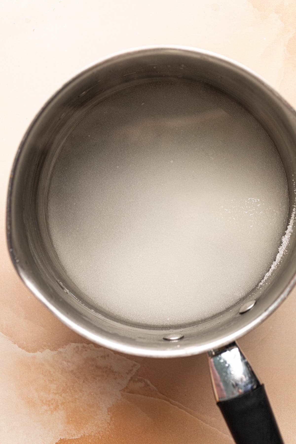 White sugar and water in a small saucepan.