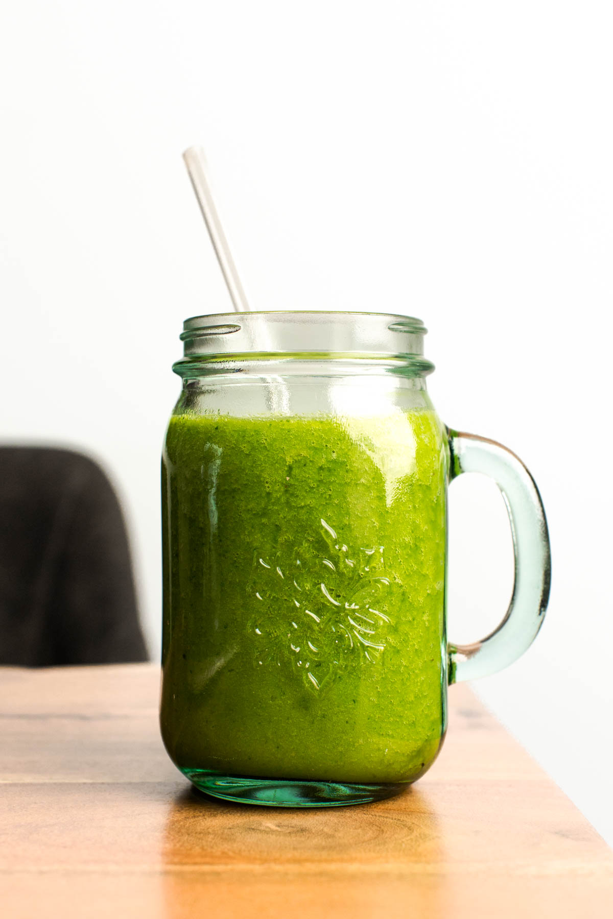 A side view of Detox Island green smoothie in a large jar.
