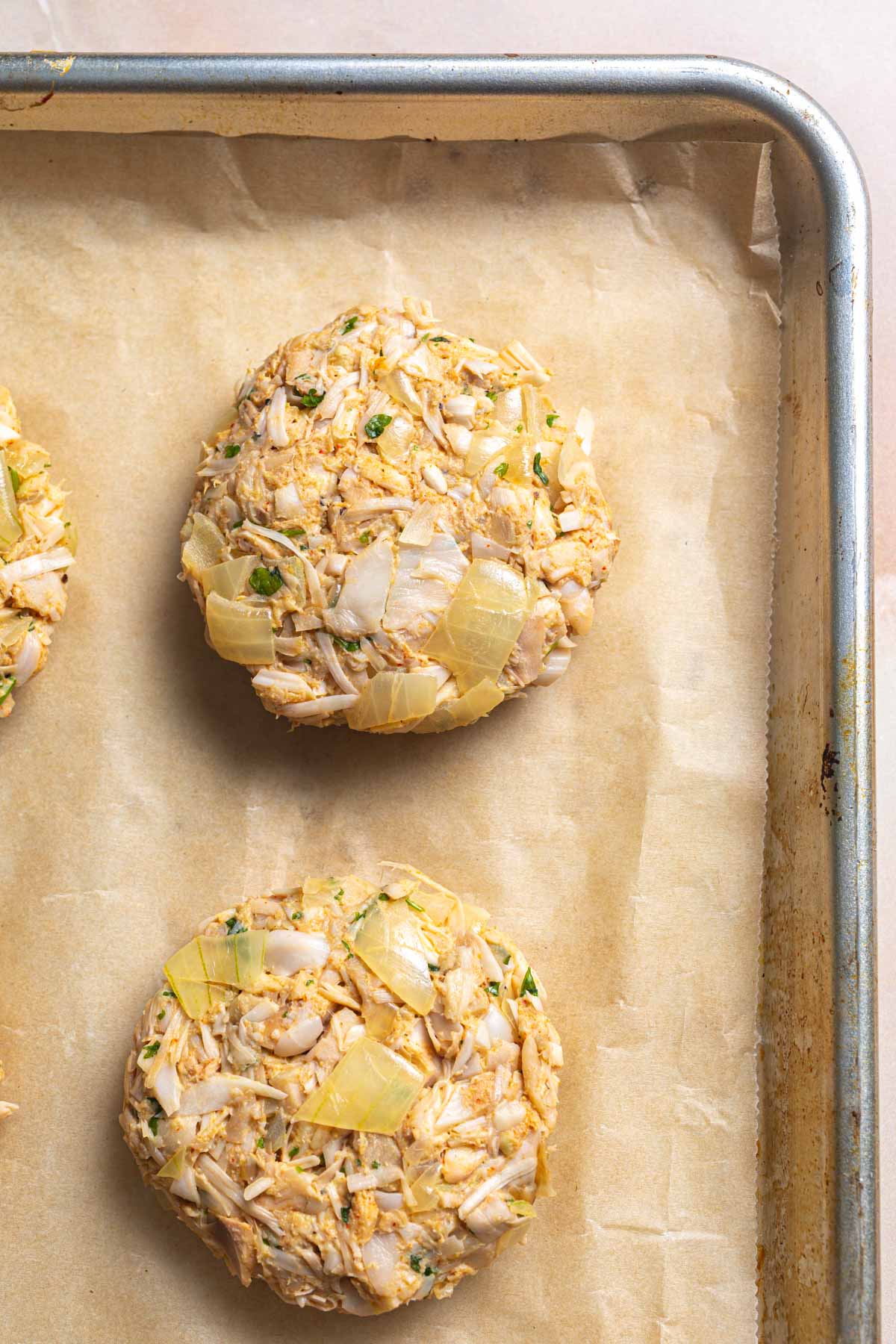 Raw jackfruit burgers on a lined sheet