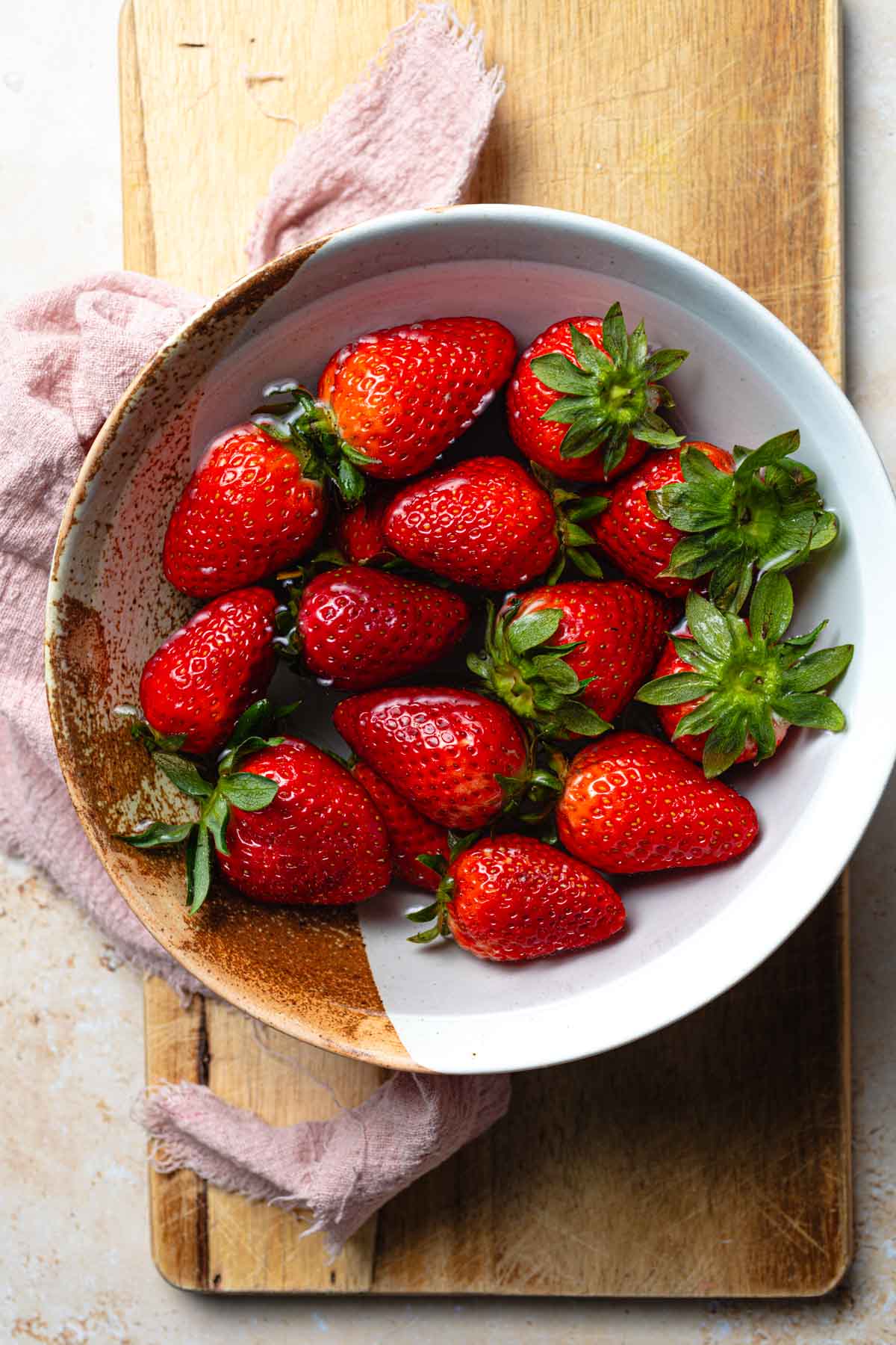 Strawberries in a bowl of water.