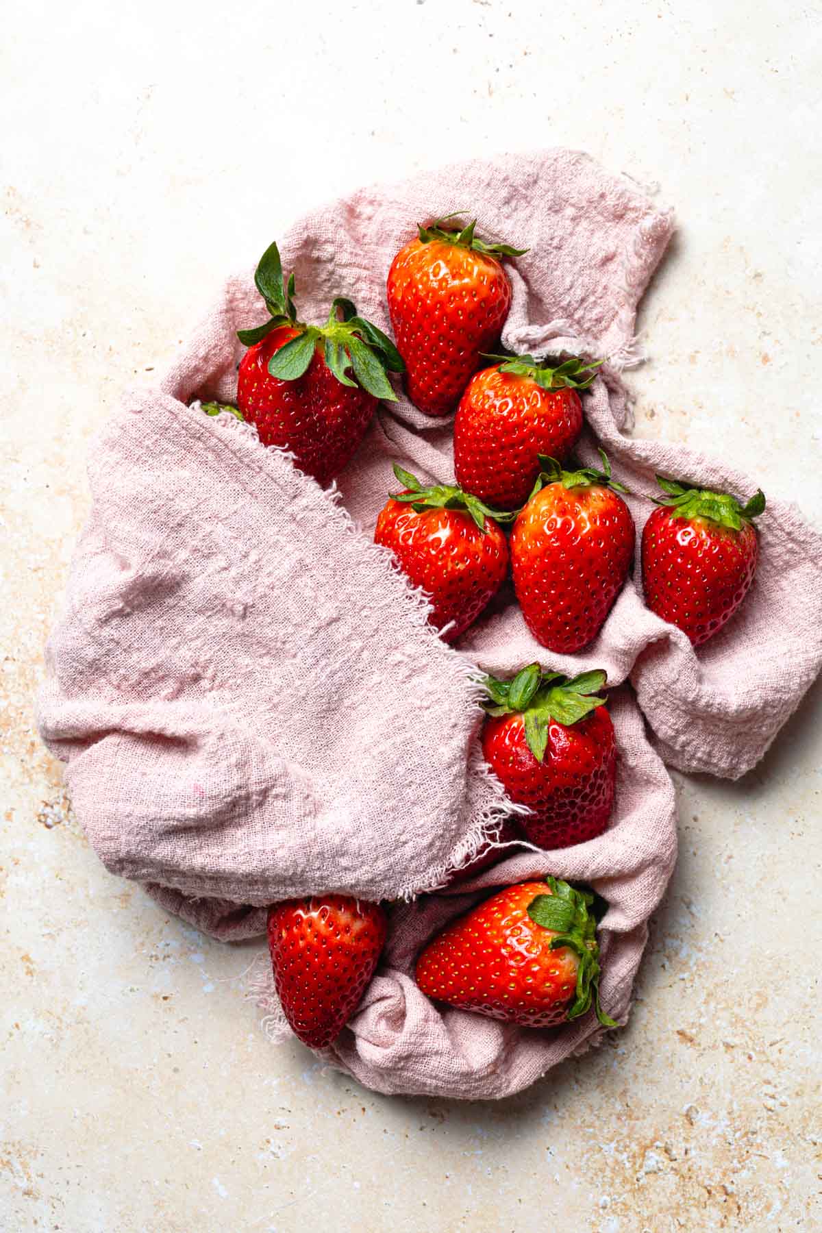 Strawberries being dried on a kitchen towel.