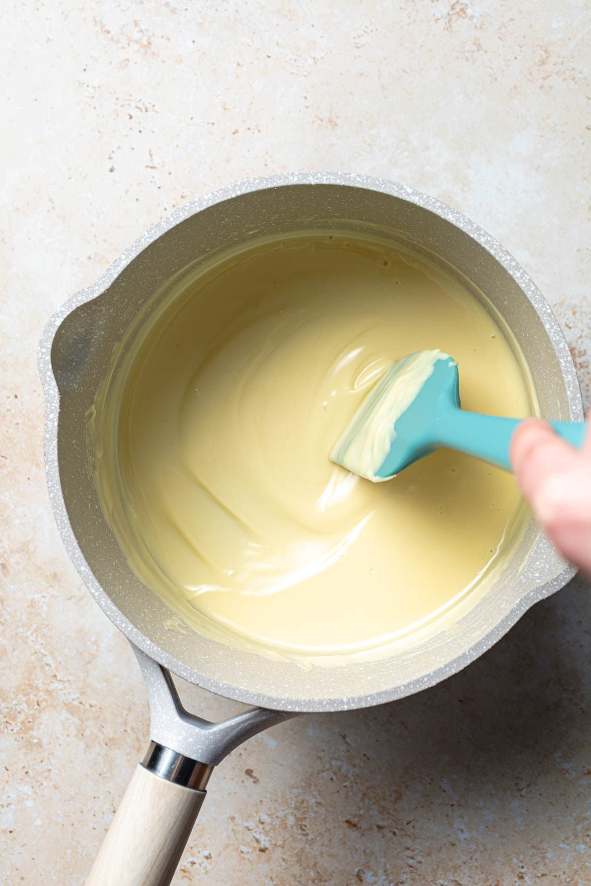 Melted white chocolate in a saucepan