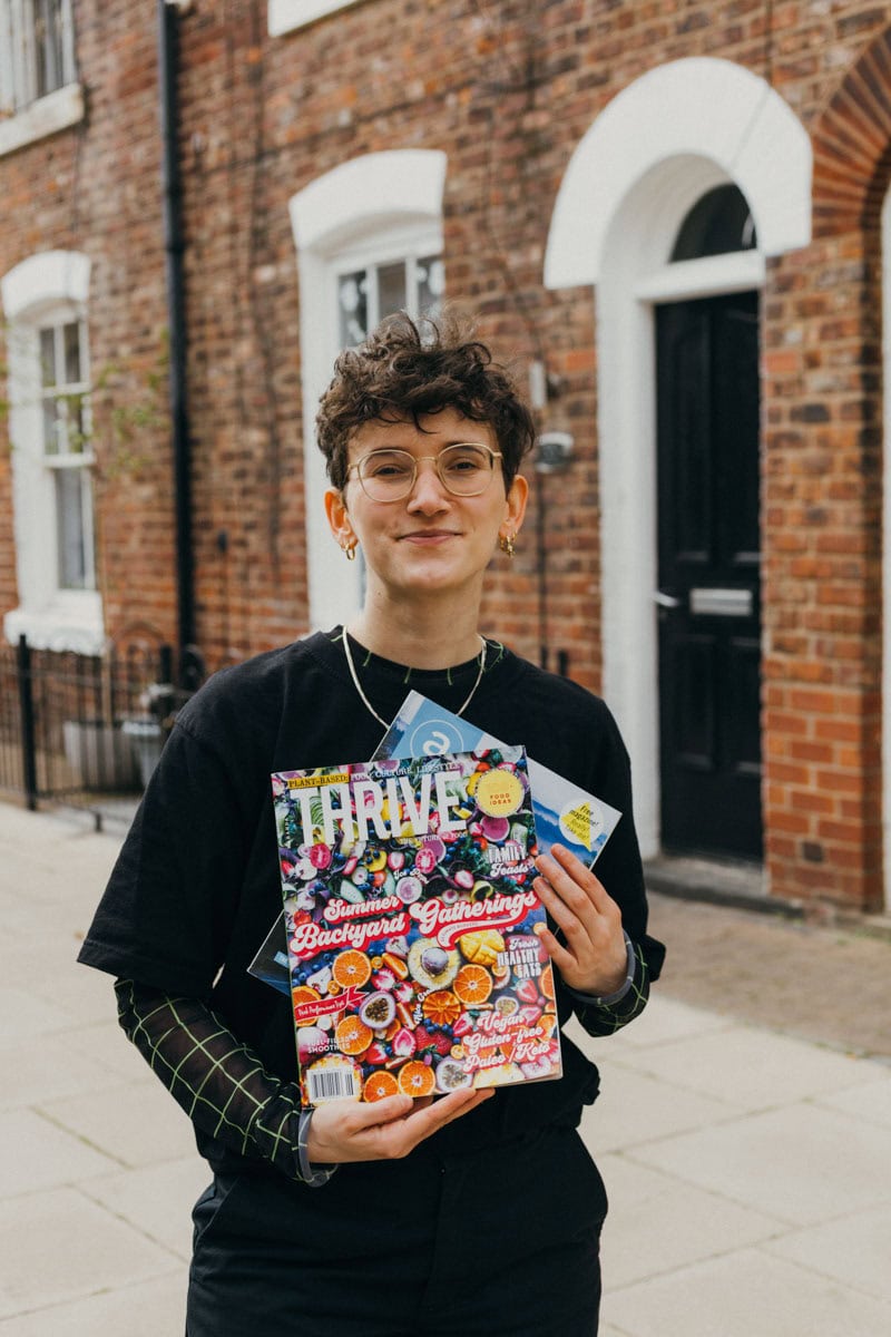 The blog author holding recipe magazines