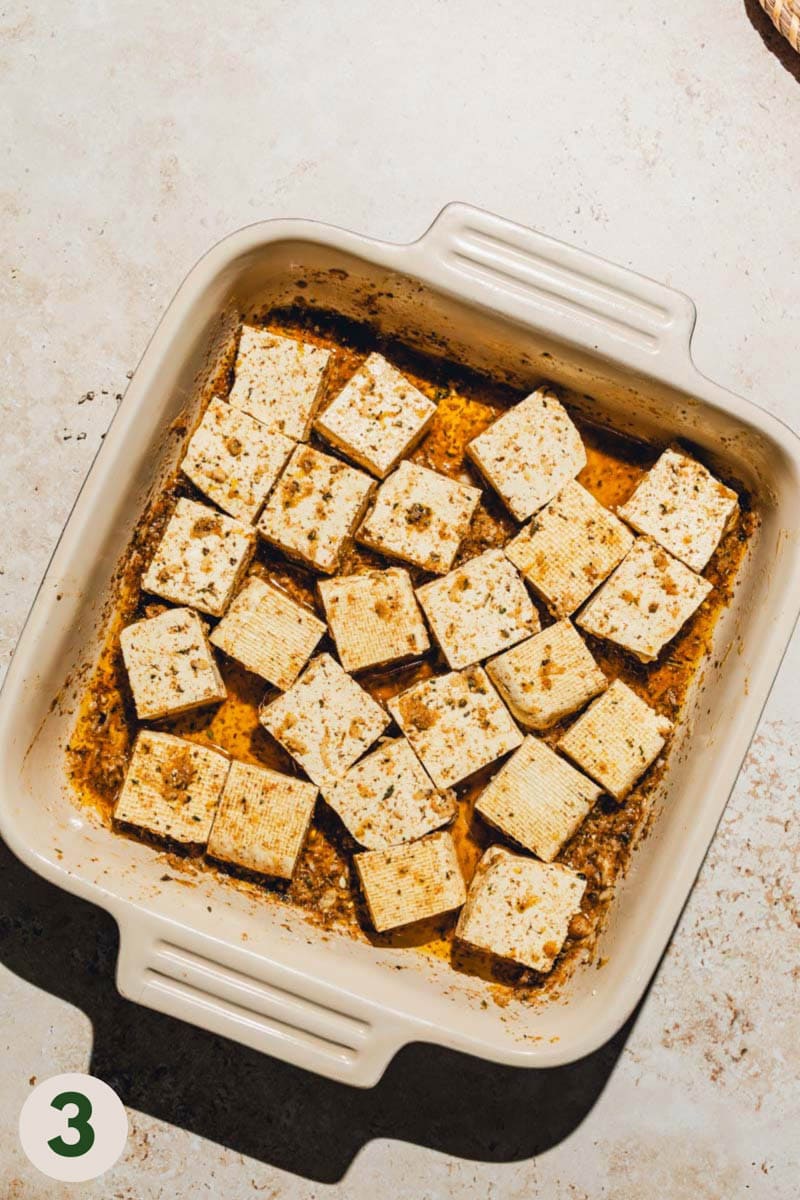 Tofu being marinated in a shallow pan