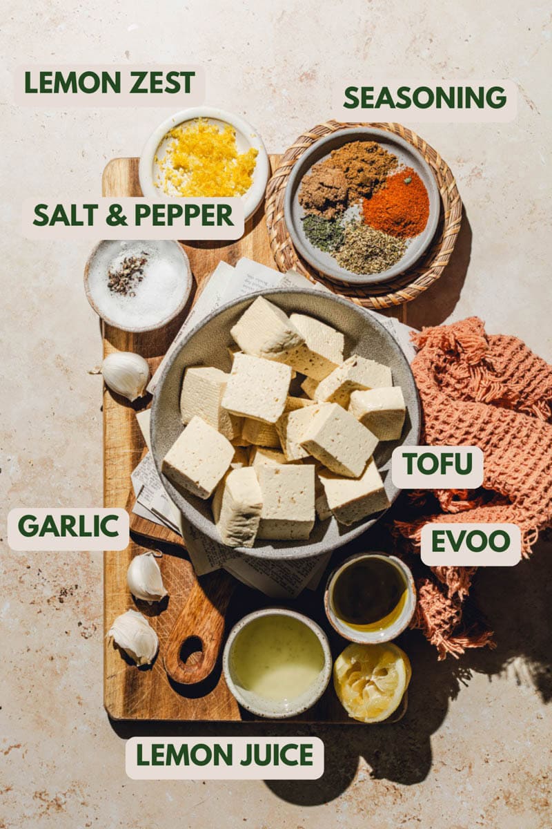 Tofu and seasoning on a wooden board