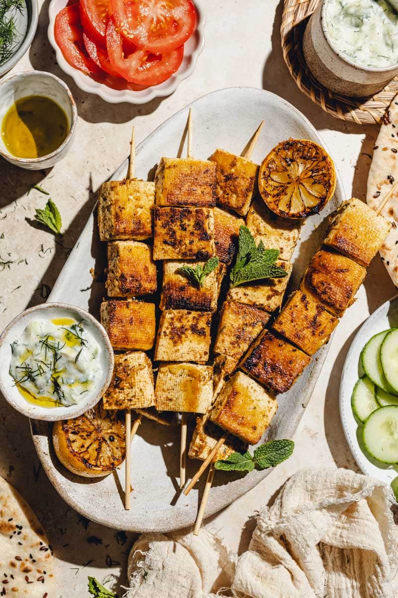Vegan souvlaki skewers on a serving plate