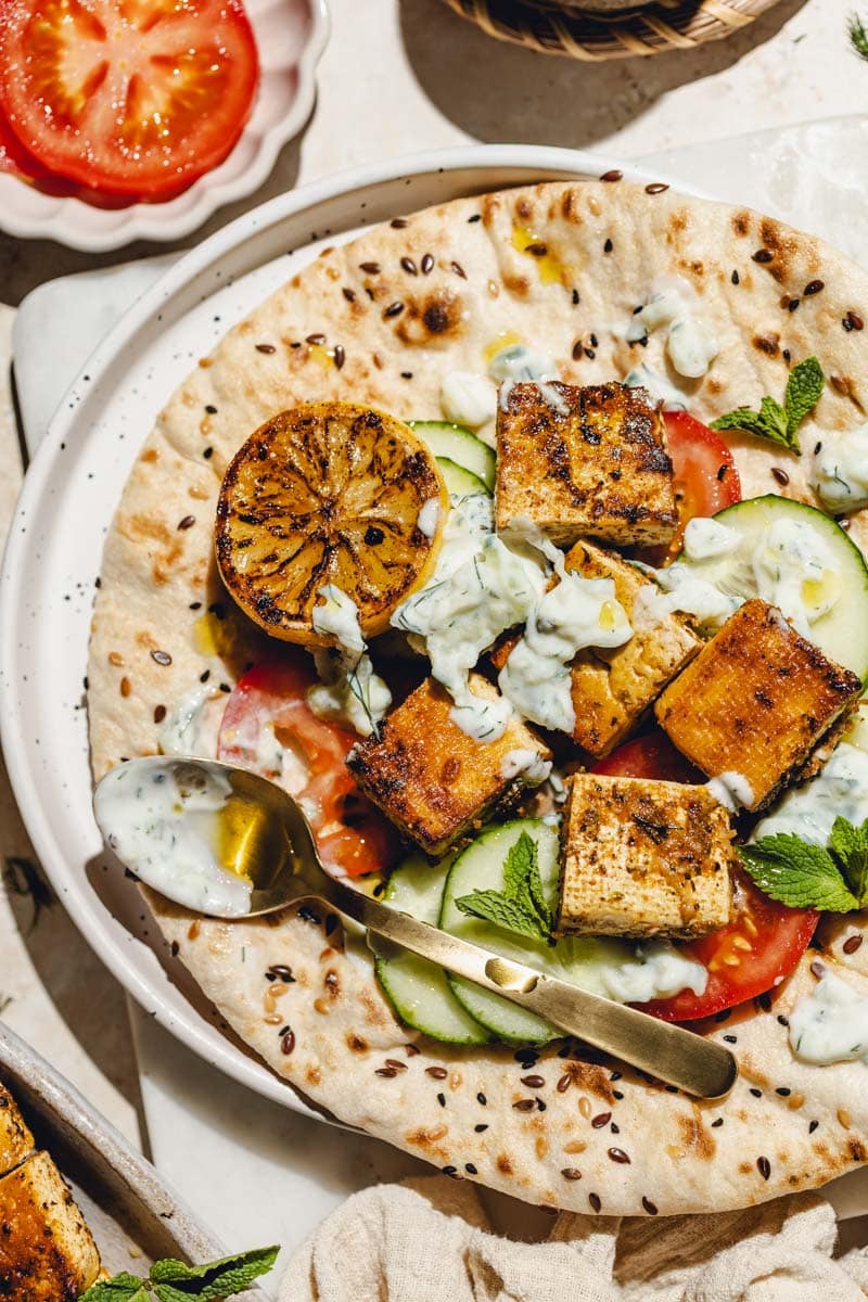 Pita with vegan souvlaki, cucumber and tomato