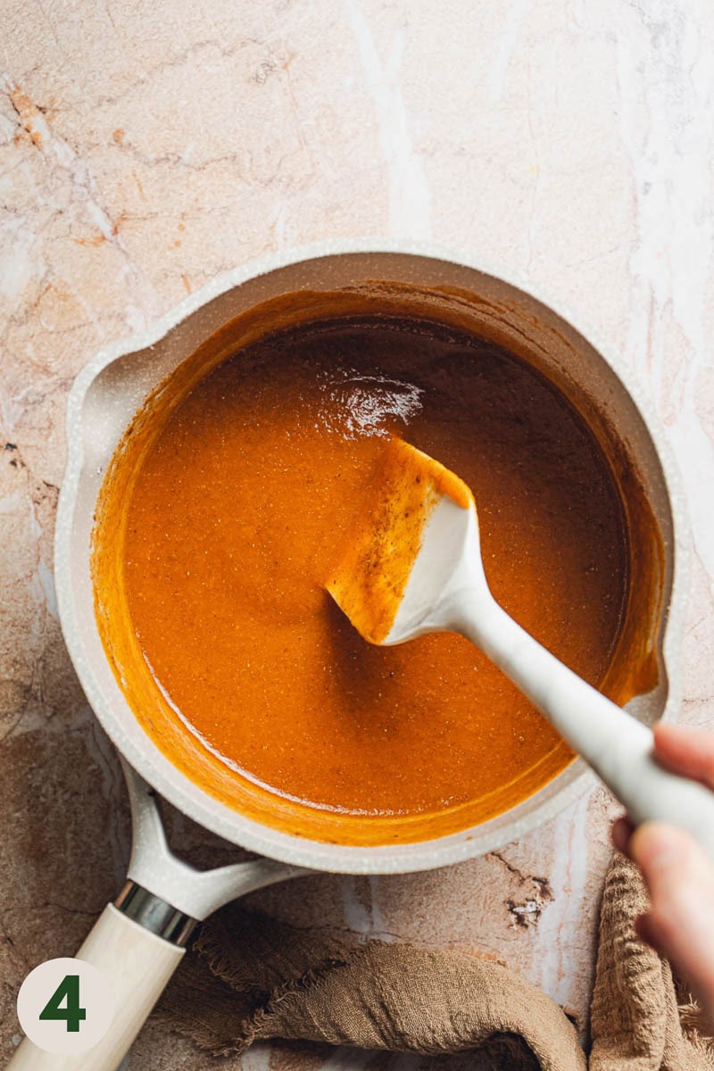 A spatula mixing an orange substance