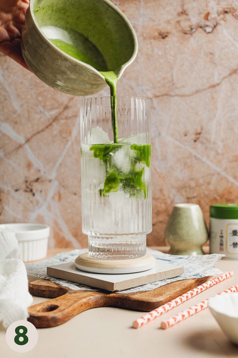 Whisked matcha being poured into a glass