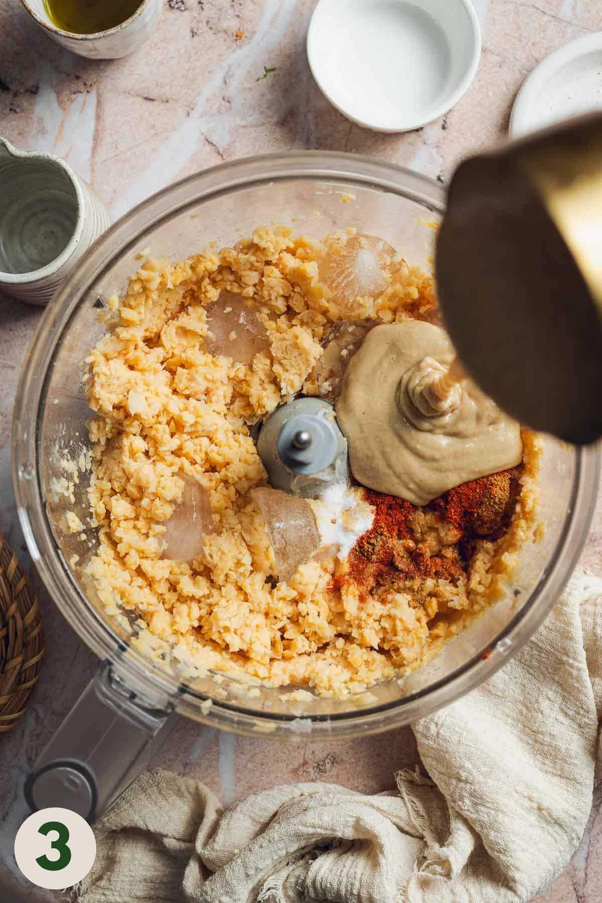 All hummus ingredients being added to food processor