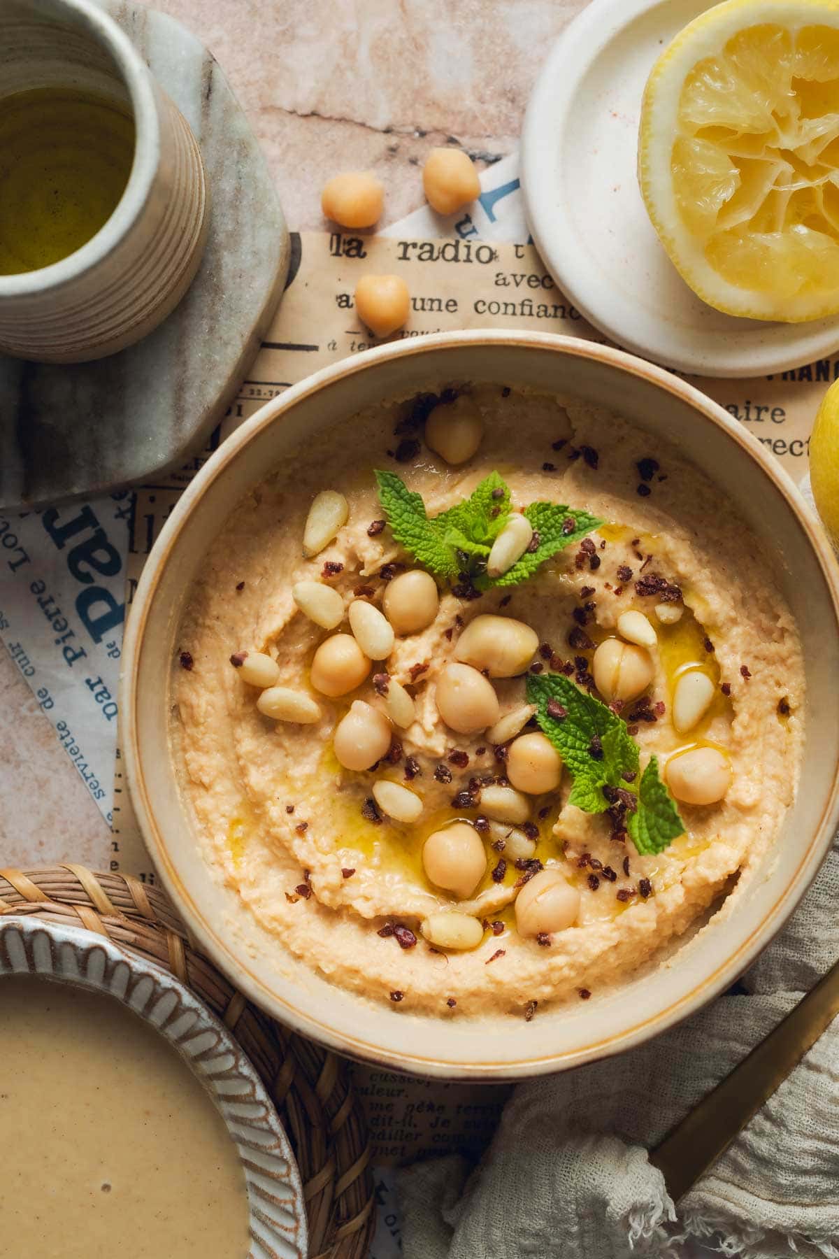 Hummus with chickpeas, mint, sumac, and olive oil topping