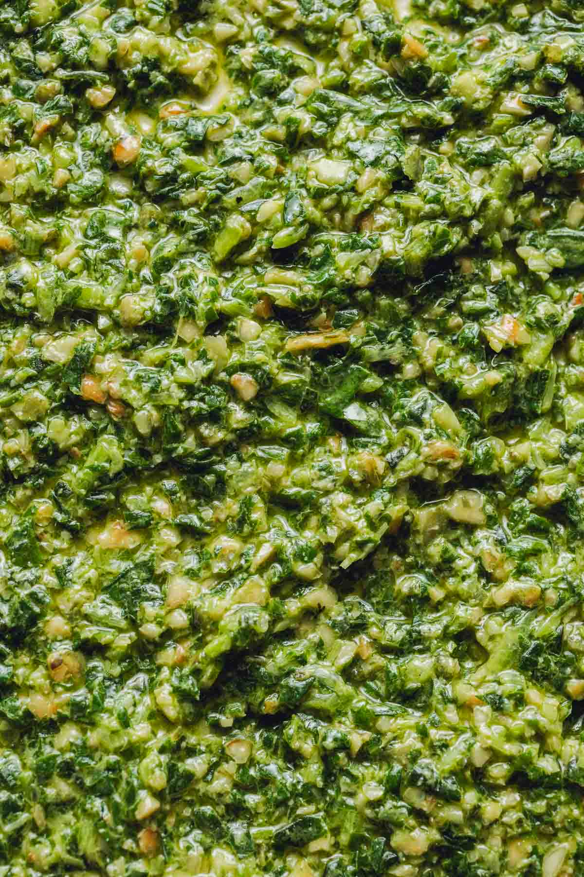 A very close-up image of green pesto