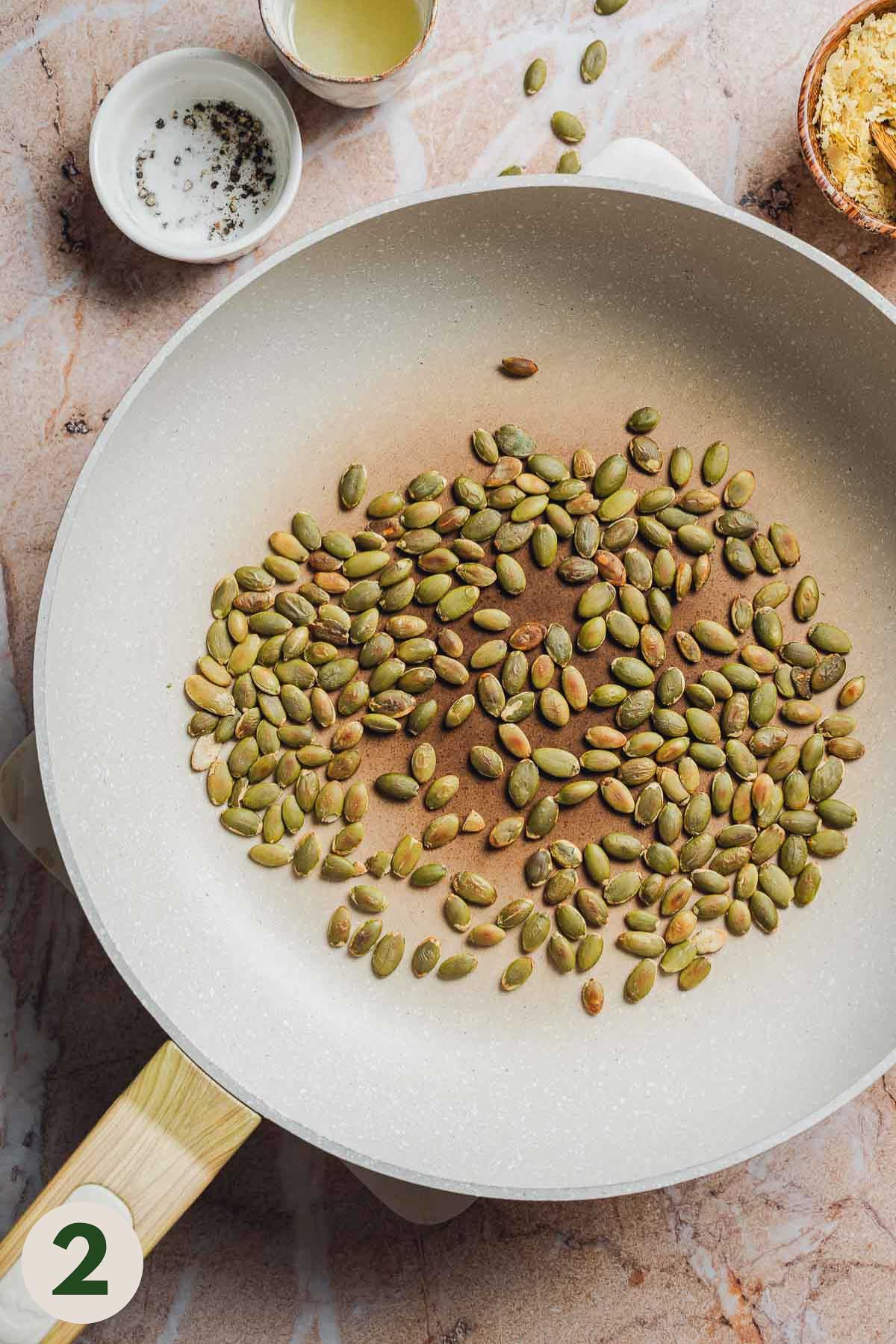Pumpkin seeds being toasted in a pan