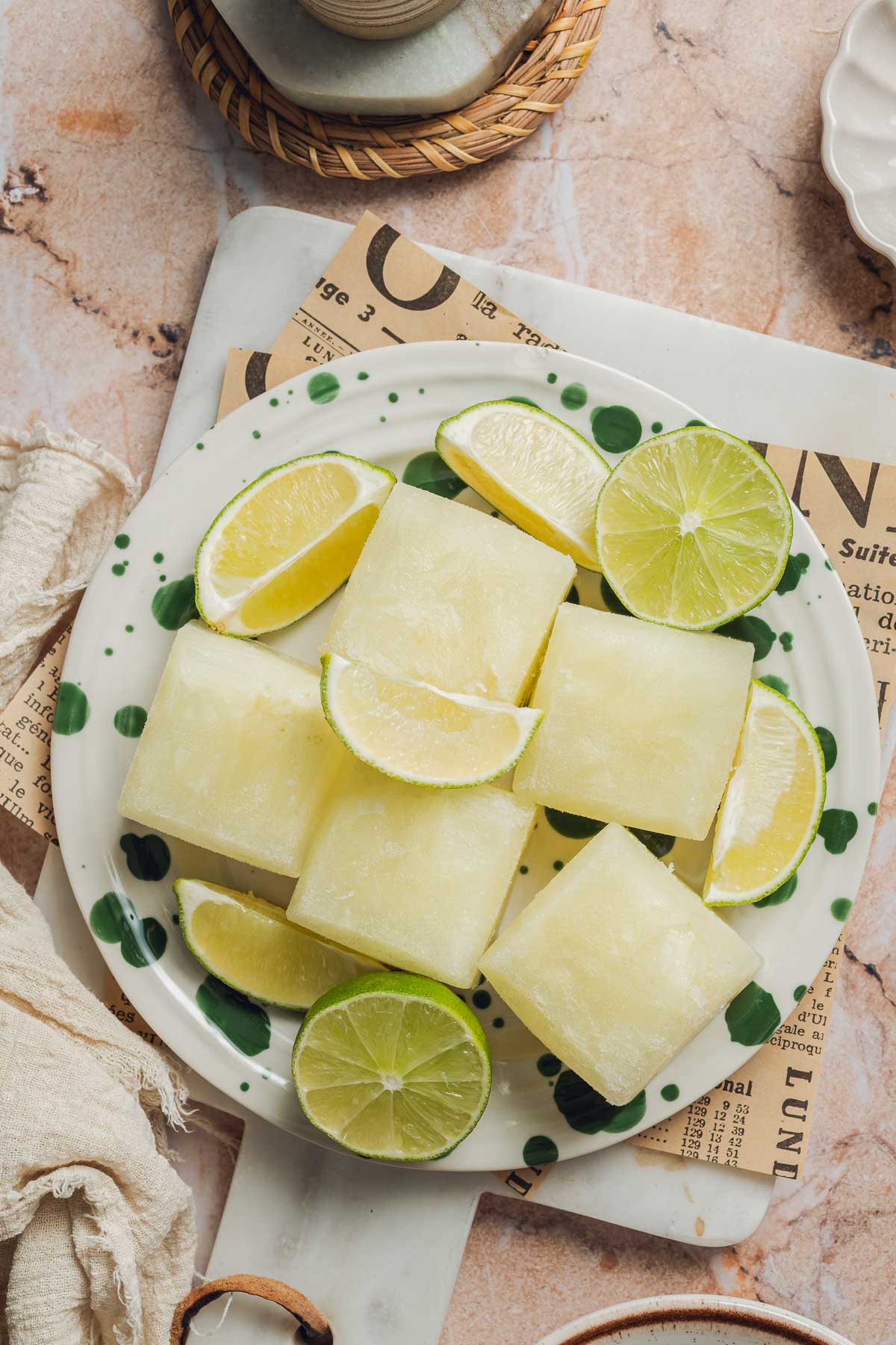 Many limeade concentrate ice cubes on a plate