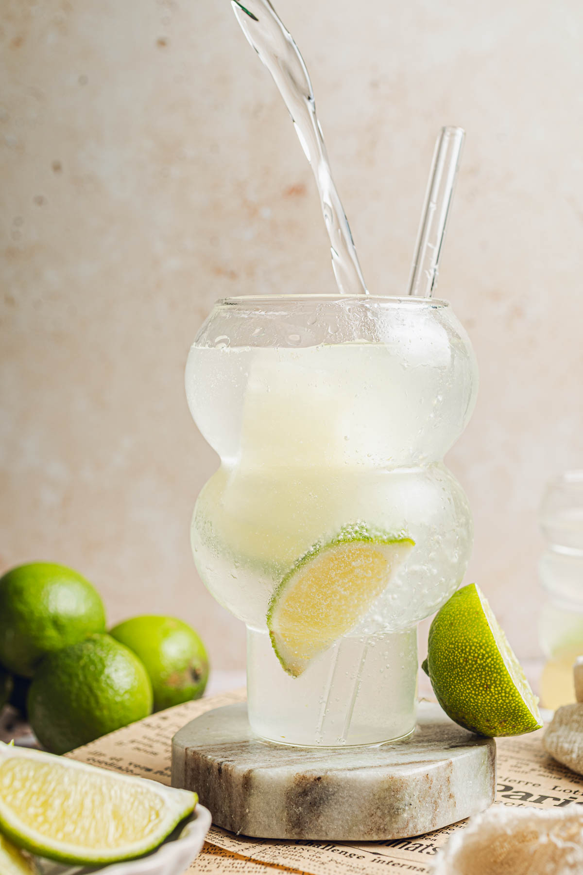 Sparkling water being poured into a glass of lime juice