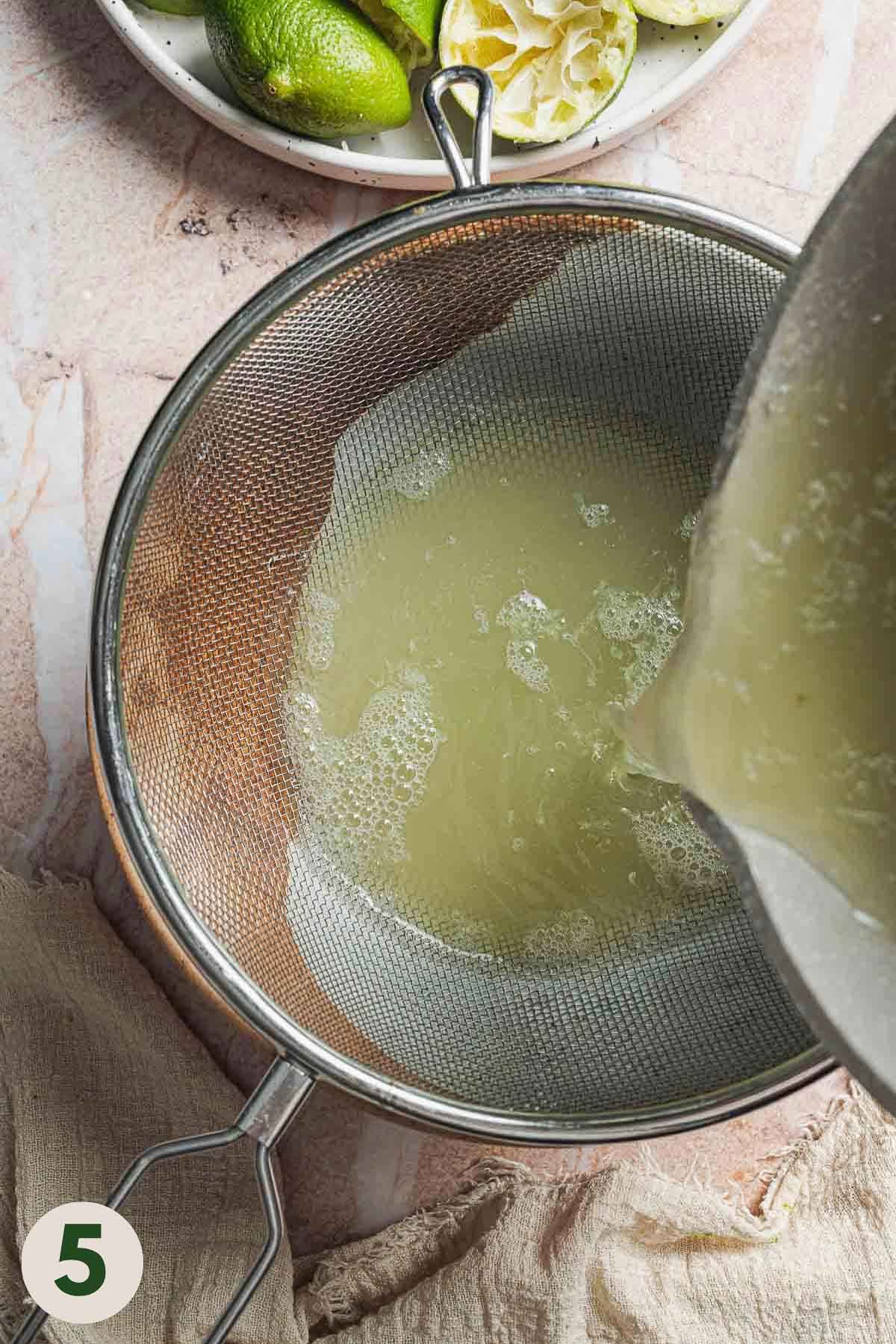 Lime concentrate being poured through a sieve into a bowl